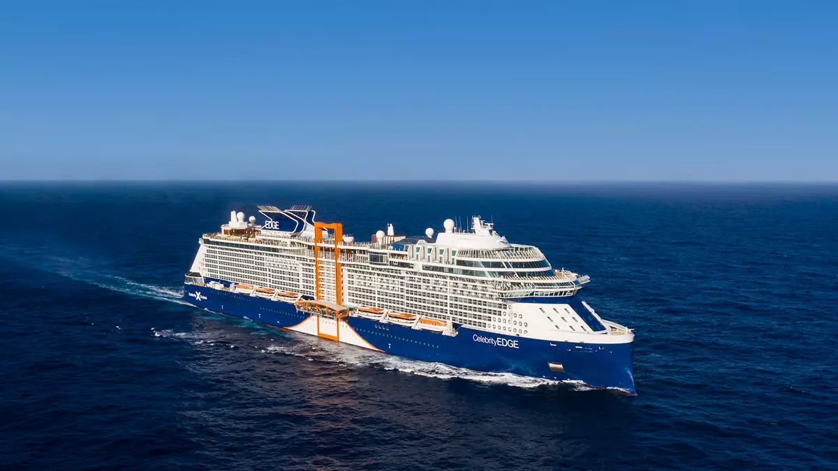 Celebrity Edge at sea, with the orange Magic Carpet on her starboard side
