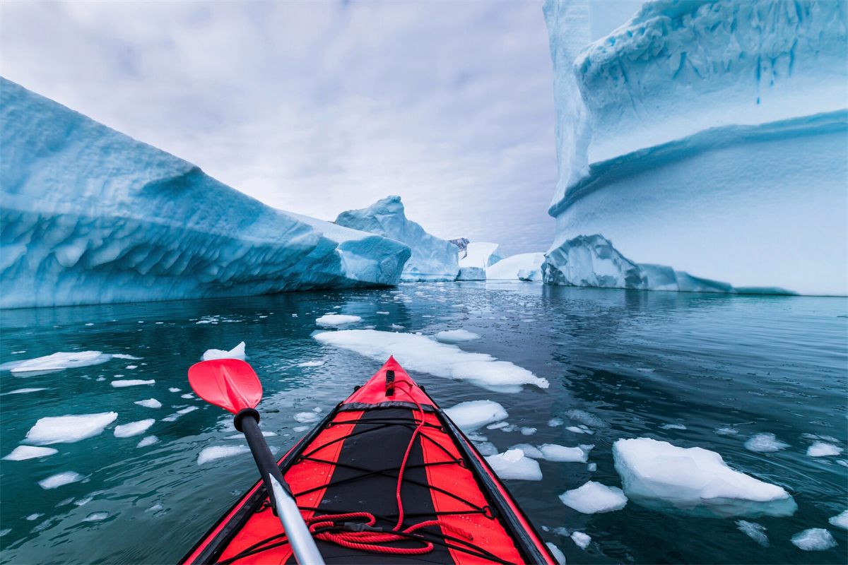 Sea kayaking among icebergs in Antarctica