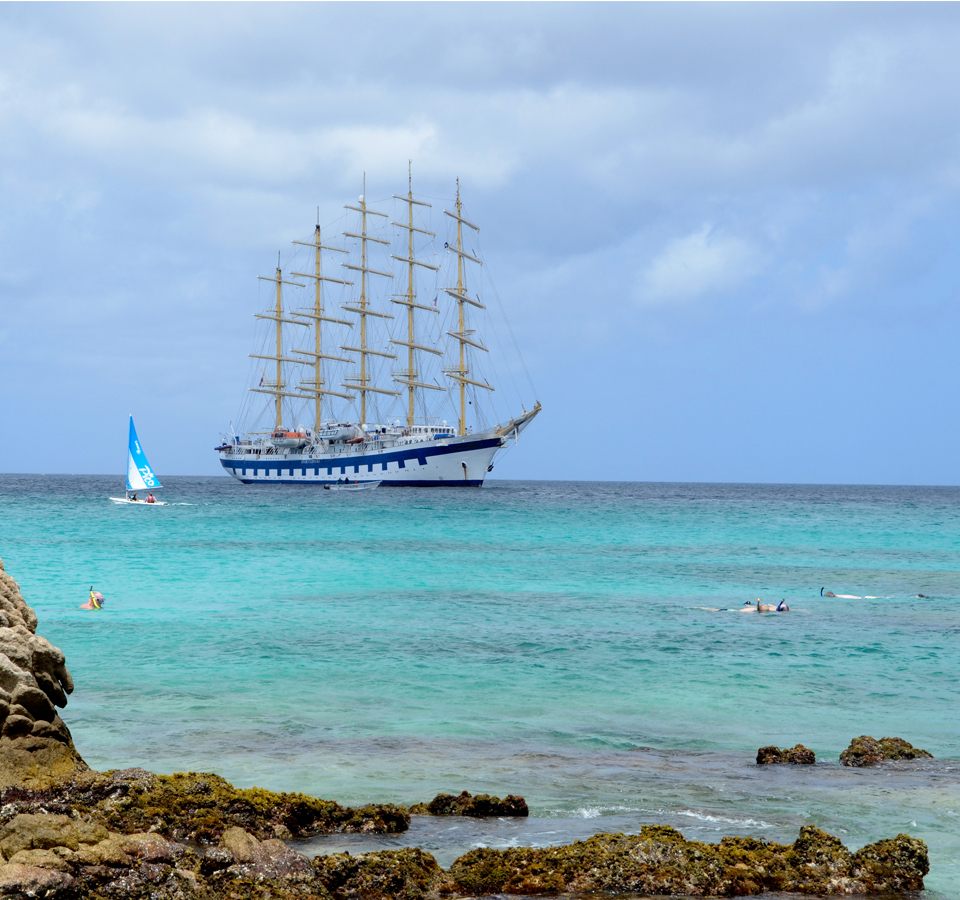 A Star Clippers ship anchored off a Caribbean lagoon